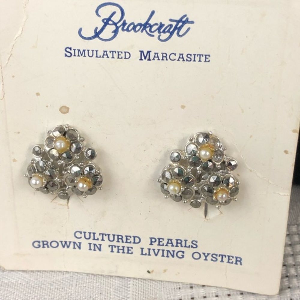Vintage clip Brookcraft earrings new on card.